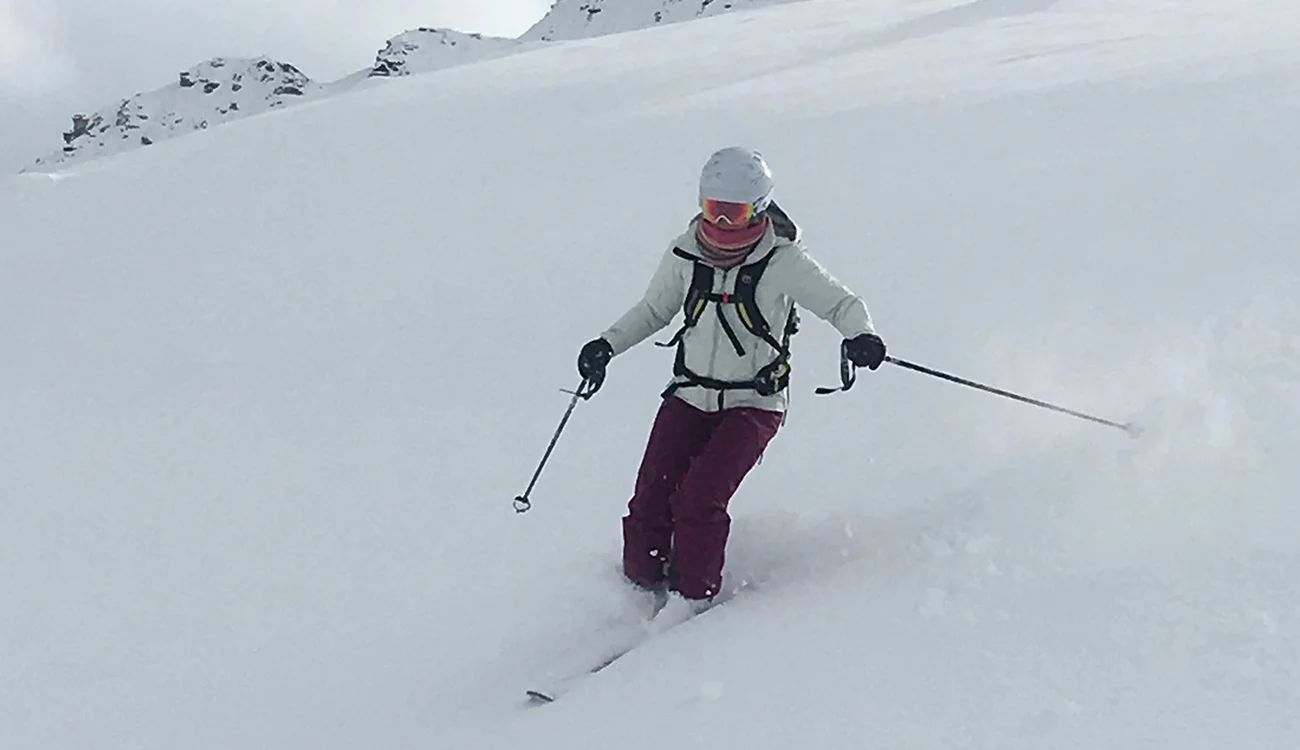 Heli-Ski Safari - Powder Skiing - Alps Skier descending deep powder snow during a heli-ski safari in the Alps