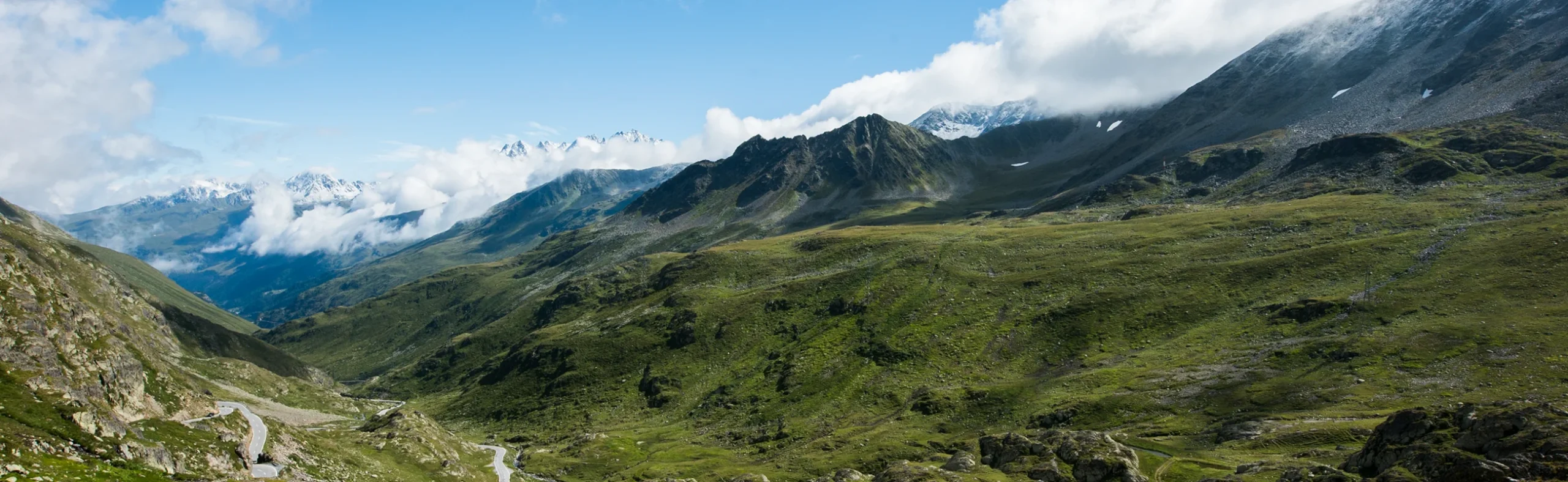 Panoramic view of a green mountain valley in the Alps