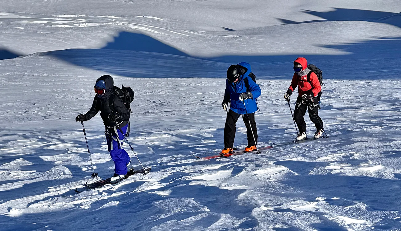 Ski Touring Safari - Glacier Crossing - Alpswebp Three ski tourers crossing a glacier in a high alpine environment