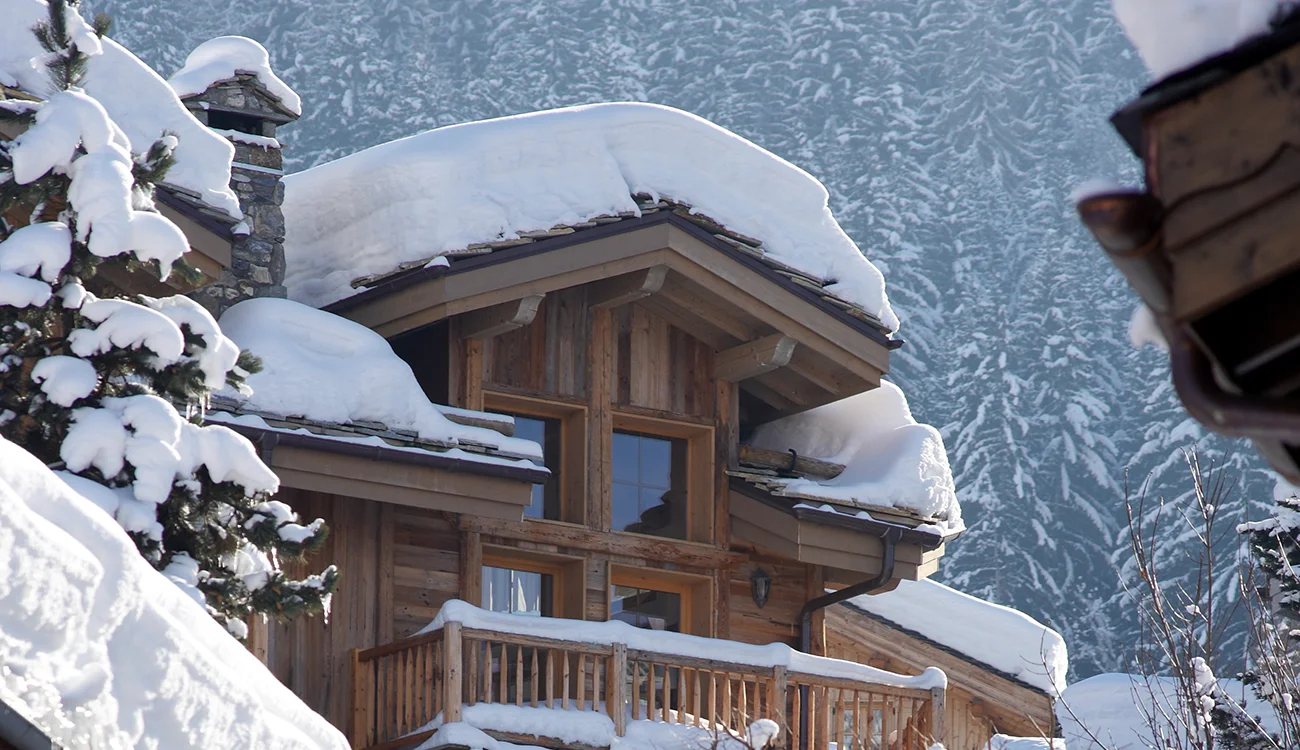 Ski Touring Safari - Luxury Hotel - Alps Luxury hotel exterior with heaps of snow on the roof in the Alps.