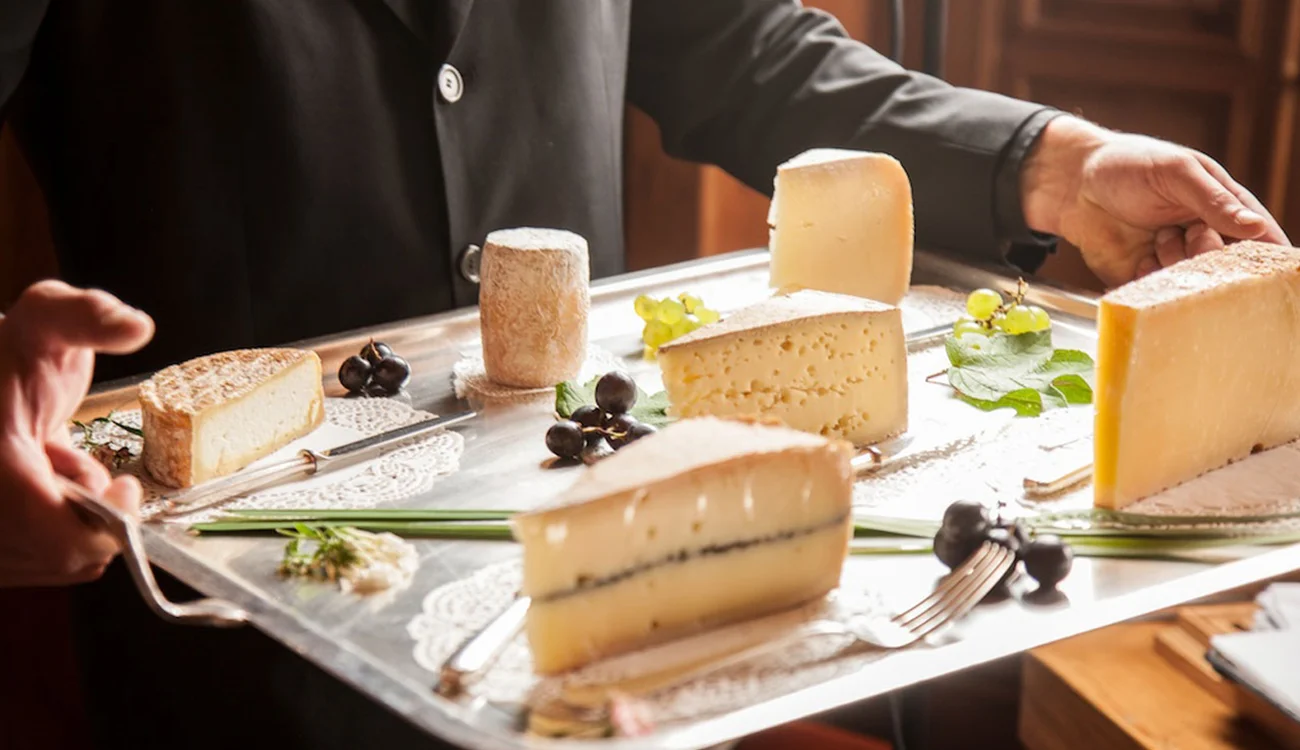 alpine-cheese-platter-swiss-mountain-dining Artisan cheese platter served at a mountain restaurant in the Alps