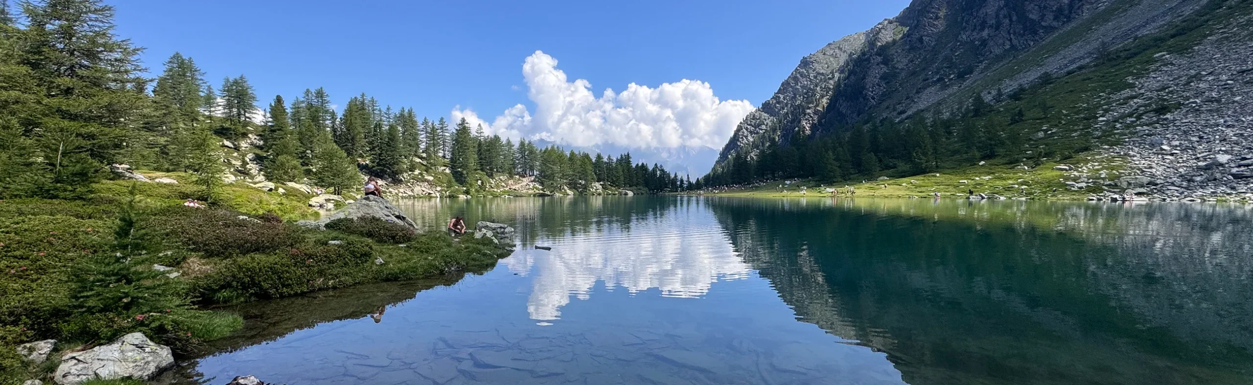 alpine-lake-panorama-switzerland-italy-france-alps Panoramic view of an alpine lake in Italy