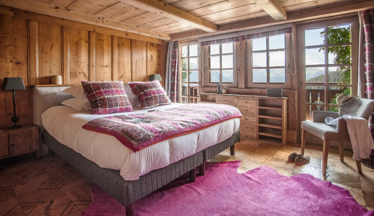 Cozy bedroom in a family-owned alpine lodge on a private safari