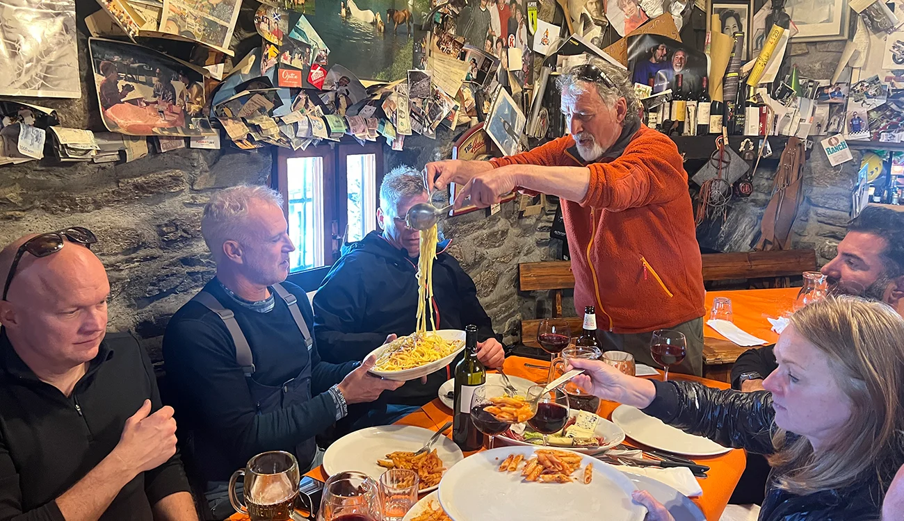 owner-serving-spaghetti-mountain-cafe-alps