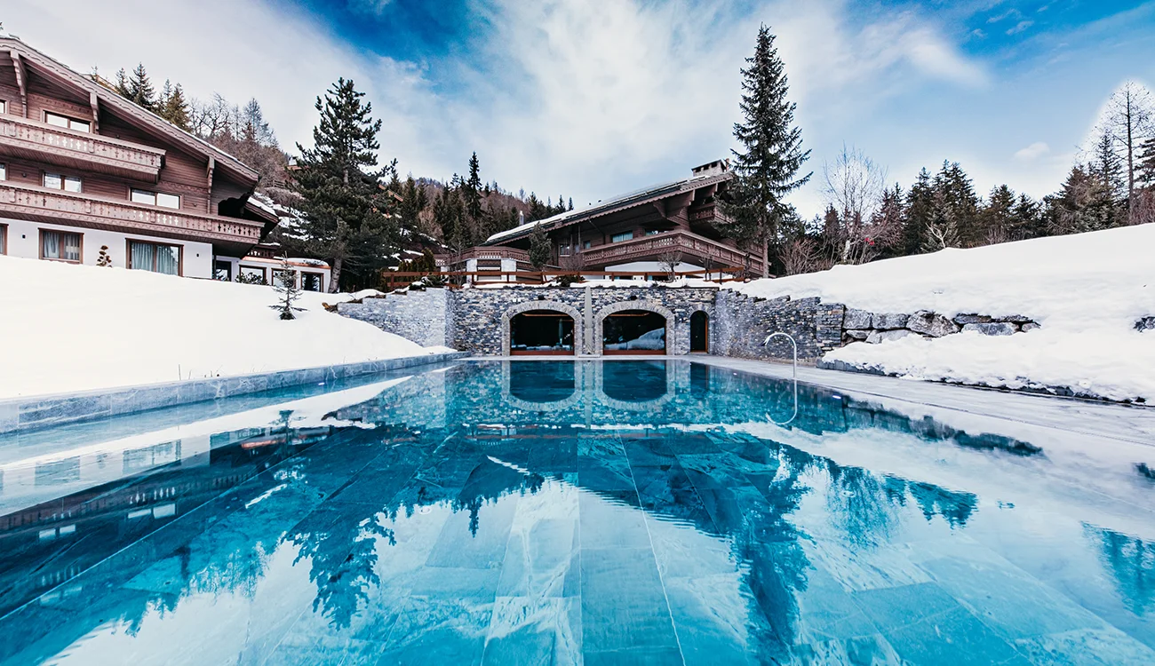 private-chalet-pool-snow-alps Private outdoor pool surrounded by snow at a luxury Alpine chalet