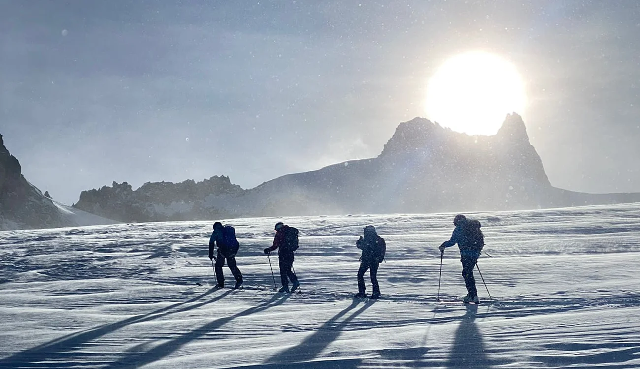 ski-touring-in-the-alps-high-altitude-safari Ski tourers climbing at high altitude in the Alps during a private guided ski touring safari